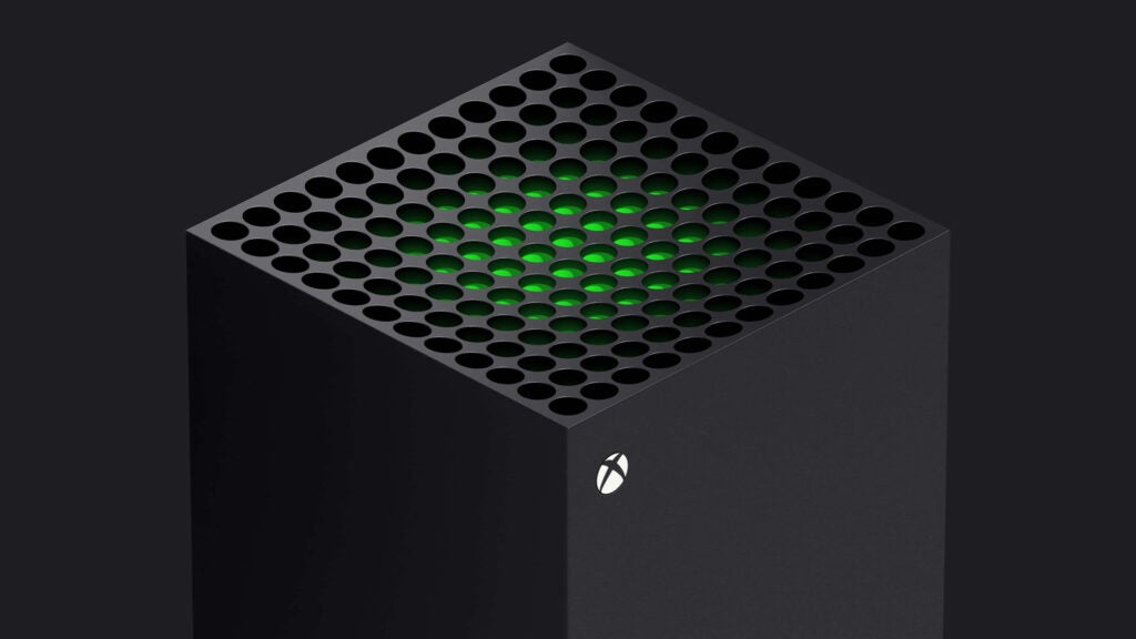 Front top side view of a black Xbox standing on black background