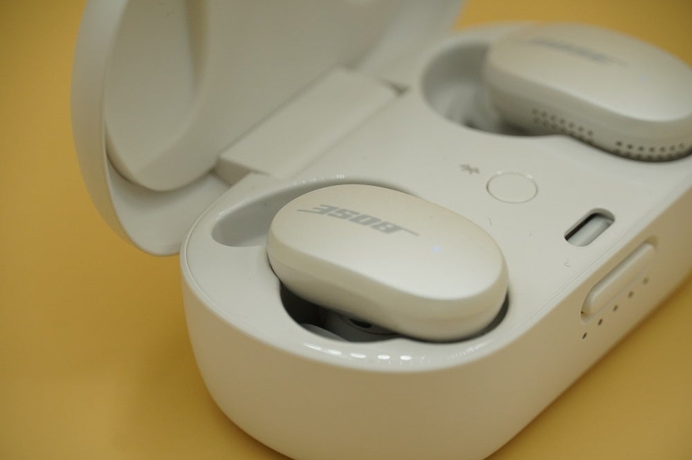 Bose QuietComfort EarbudsLeft angled view of white Bose QuietComfort earbud's resting in it's white case