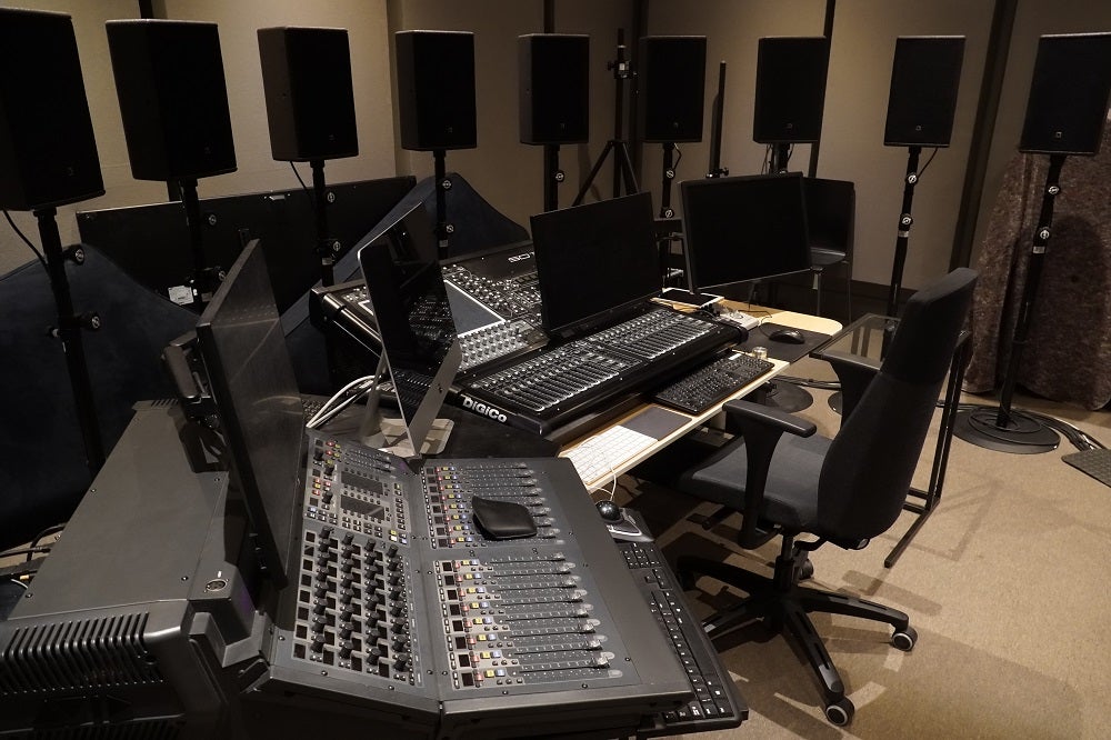 Picture of L Acoustics Mixing room with number of screens, speakers and amplifiers