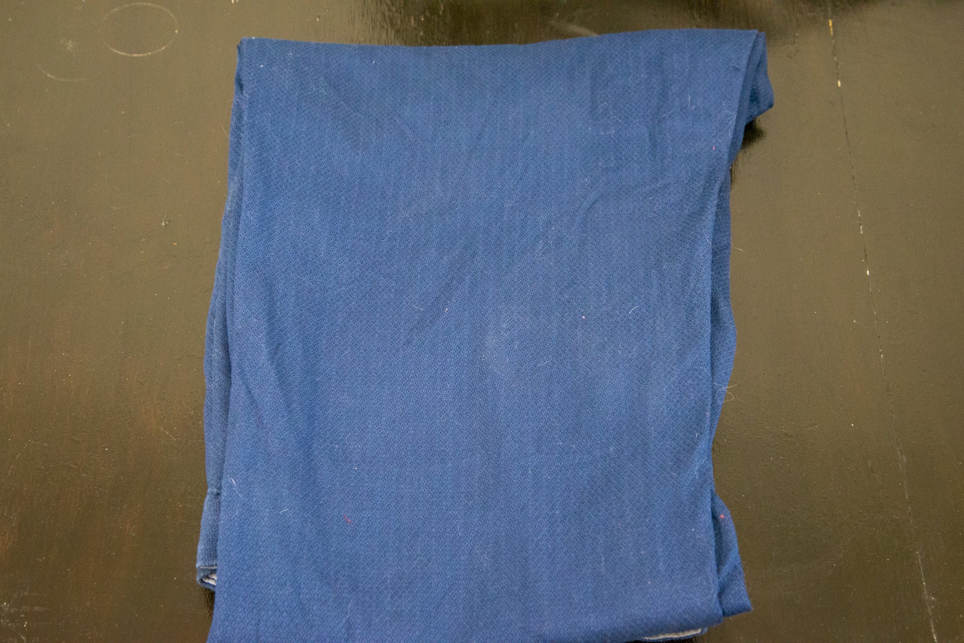 A blue cloth kept on a wooden table