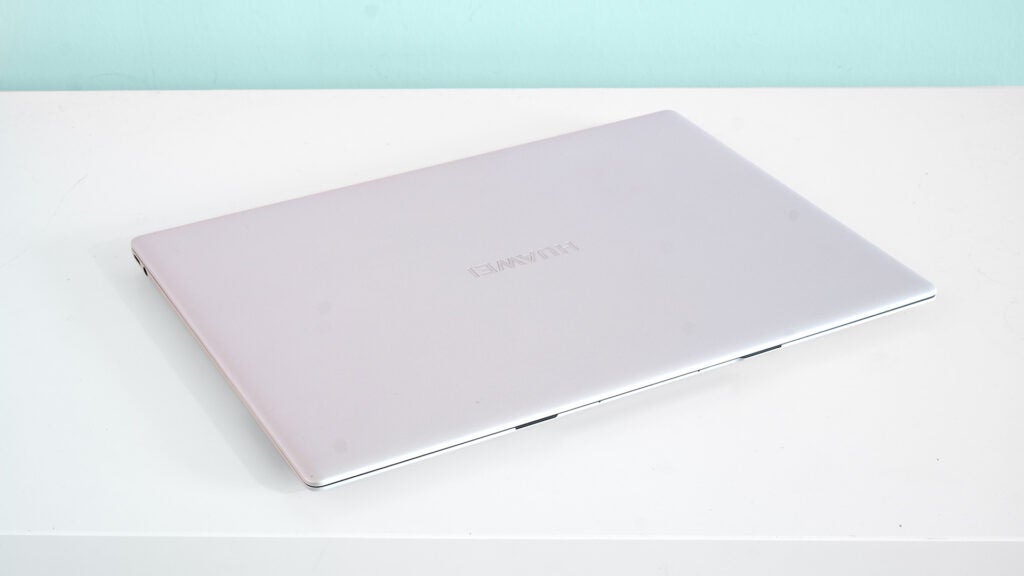 A closed white Huawei Matebook X Pro kept on a white table