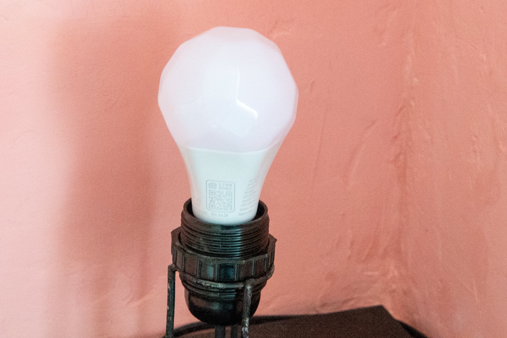 A Nanoleaf colored bulb fixed in a holder kept in a corner