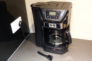 A black and silver Russell Hobbs grinder and brewer plugged in