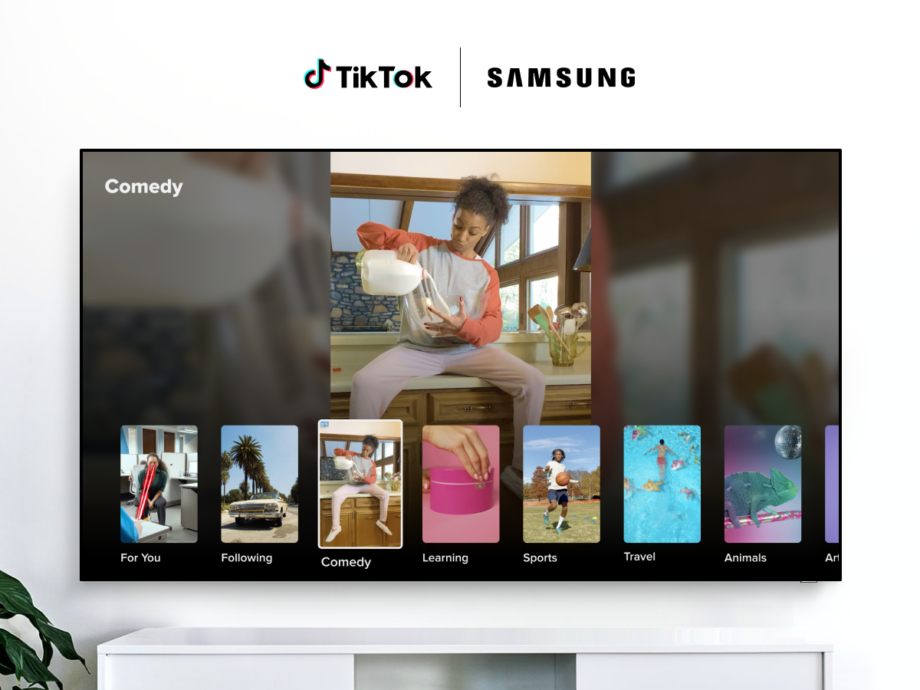 A black Samsung TV hanging to a white wall, displaying videos from TikTok