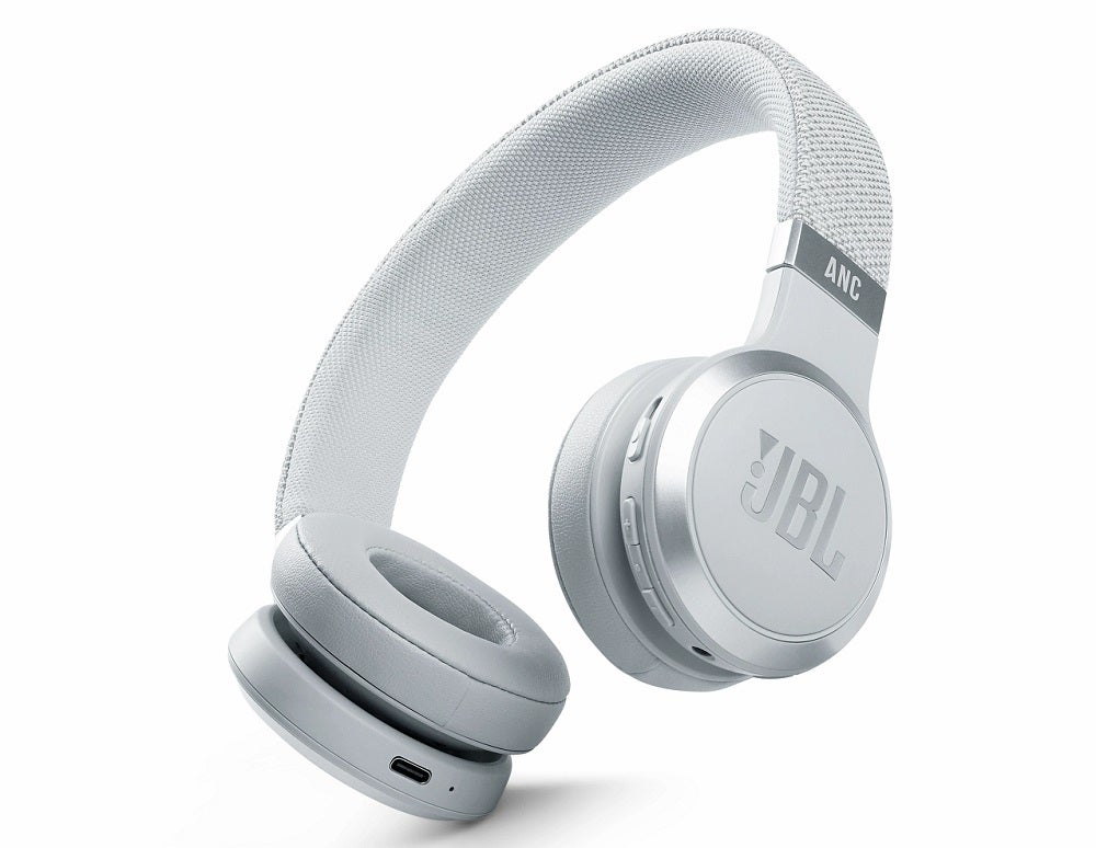 Silver-white JBL Live 460NC headphones standing in white background