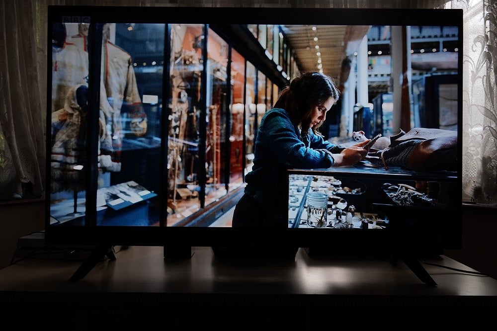 His Dark Materials on LG 50UN70006LAwell captured picture of worried woman from BBC channel clearly displayed on wide screen TV on tableA black LG50UN70006LA TV standing on a table, displaying a scene from His Dark Materials 2