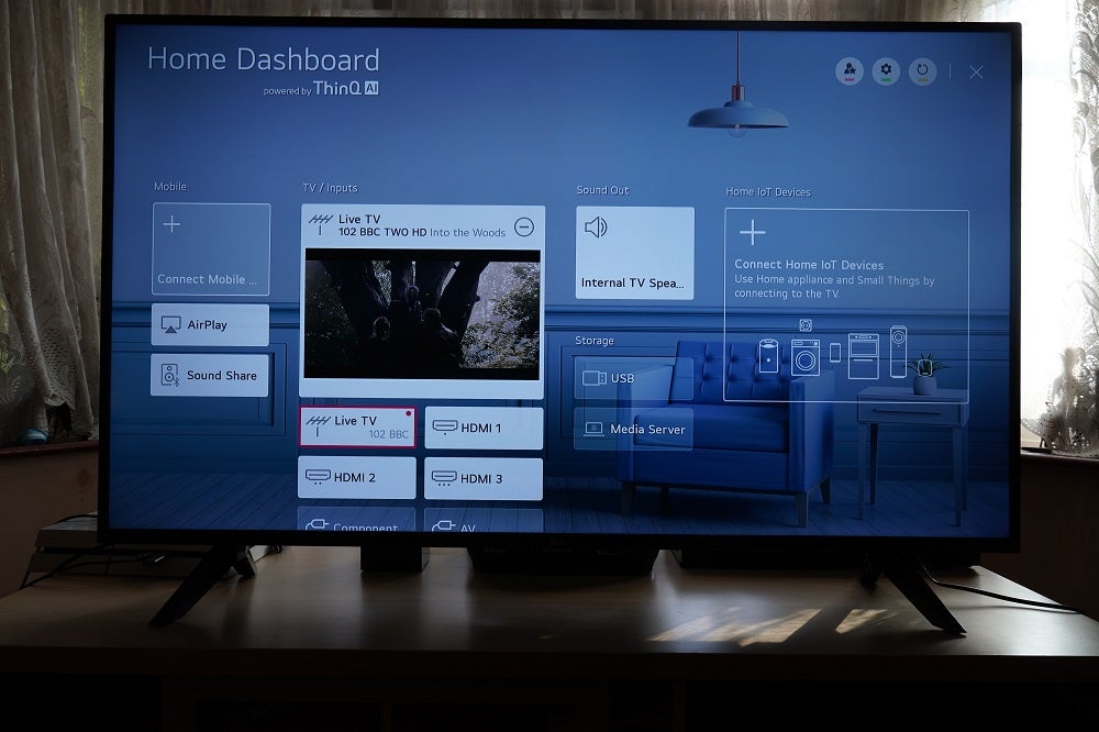 ThinQ AI dashboard on LG UN70A black LG50UN70006LA TV standing on a table, displaying home dashboard powered by ThinQ-AI