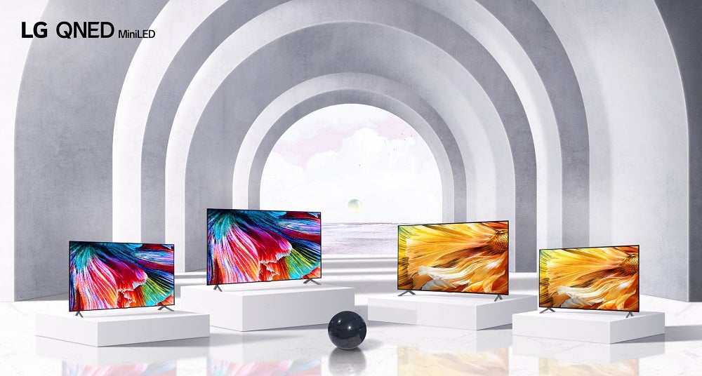 Four LG QNED Mini LED TVs standing on white pillars on white background