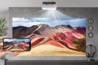 A white LG Cinebeam 4K projector attached to roof, displaying a picture of mountains via Airplay