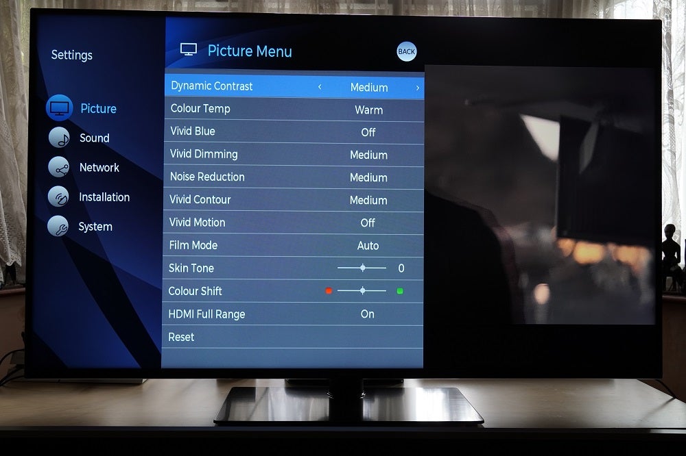 A black Panasonic HX600 TV standing on a table, displaying a picture settings menu