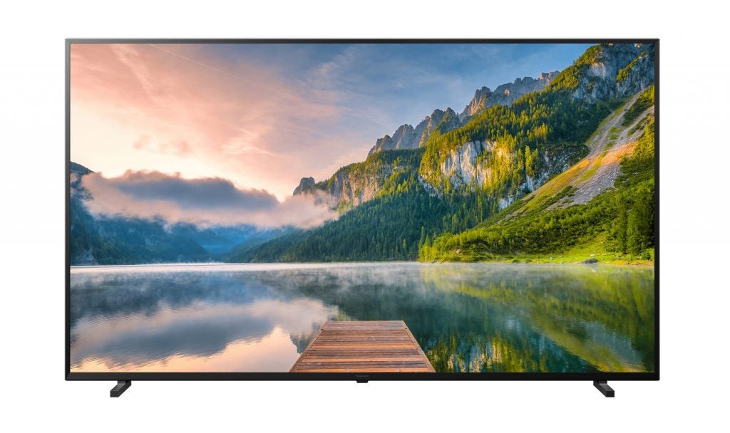 A black Panasonic JX800 TV standing on a white background displaying a scenery 
