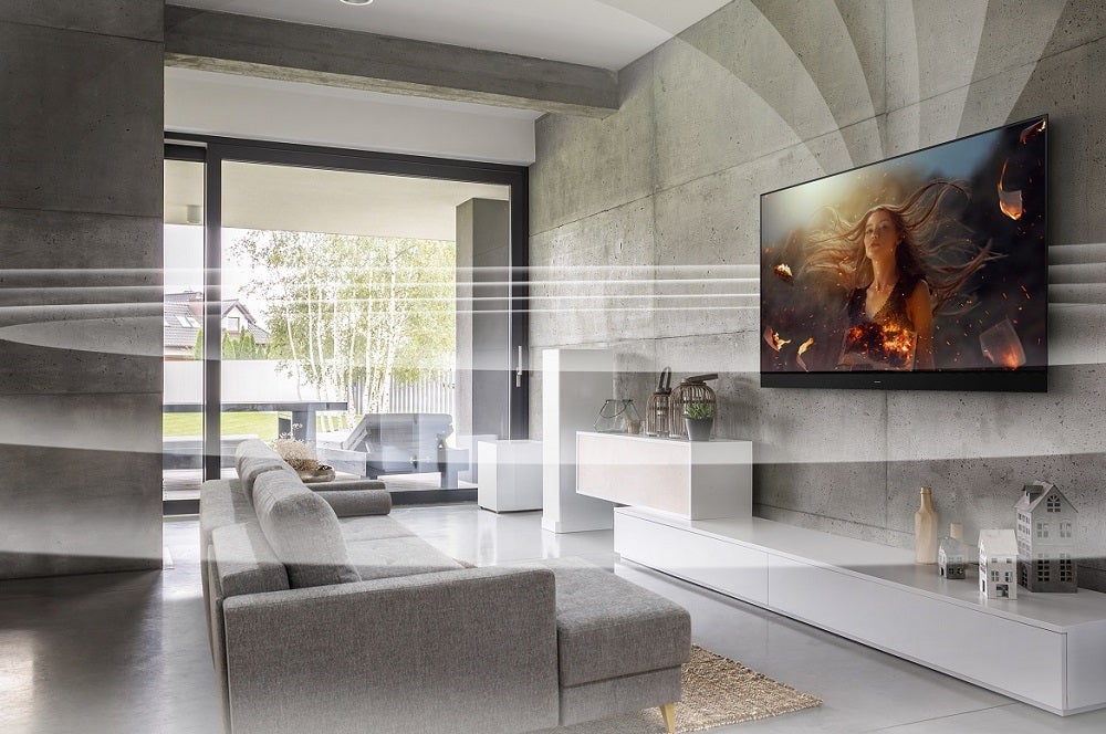 A Panasonic JZ2000 TV hanging to a wall with white circle around it, showing 360 soudspace technology