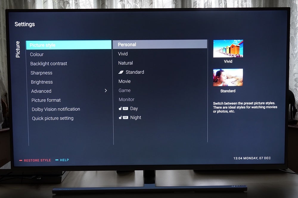 A black Philips 50PUS8545 TV standing on table, displaying picture and style settings menu