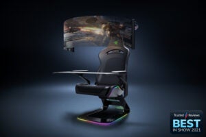 A black gaming chair standing in blue-black background, with colorful lights on corner edges of chair