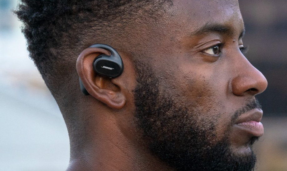 Close up image of man's right profile wearing black Bose earbuds