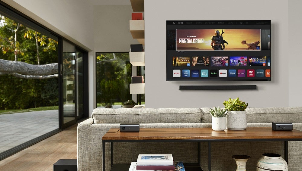 A TV hanging to a wall in living room, showcasing Vizio smart cast