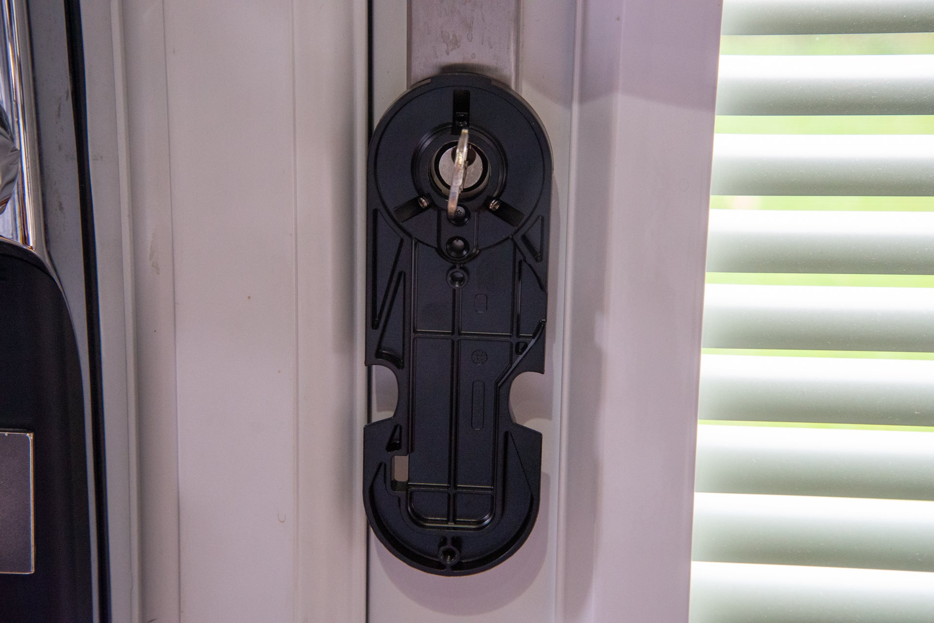 A black Yale linus smart door lock fixed on the door