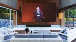 L Acoustics Creations Archipel Lorde sound sytems hangin beside a screen in a living room