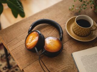 Black and gold ATH WP900 headphones resting on a wooden table
