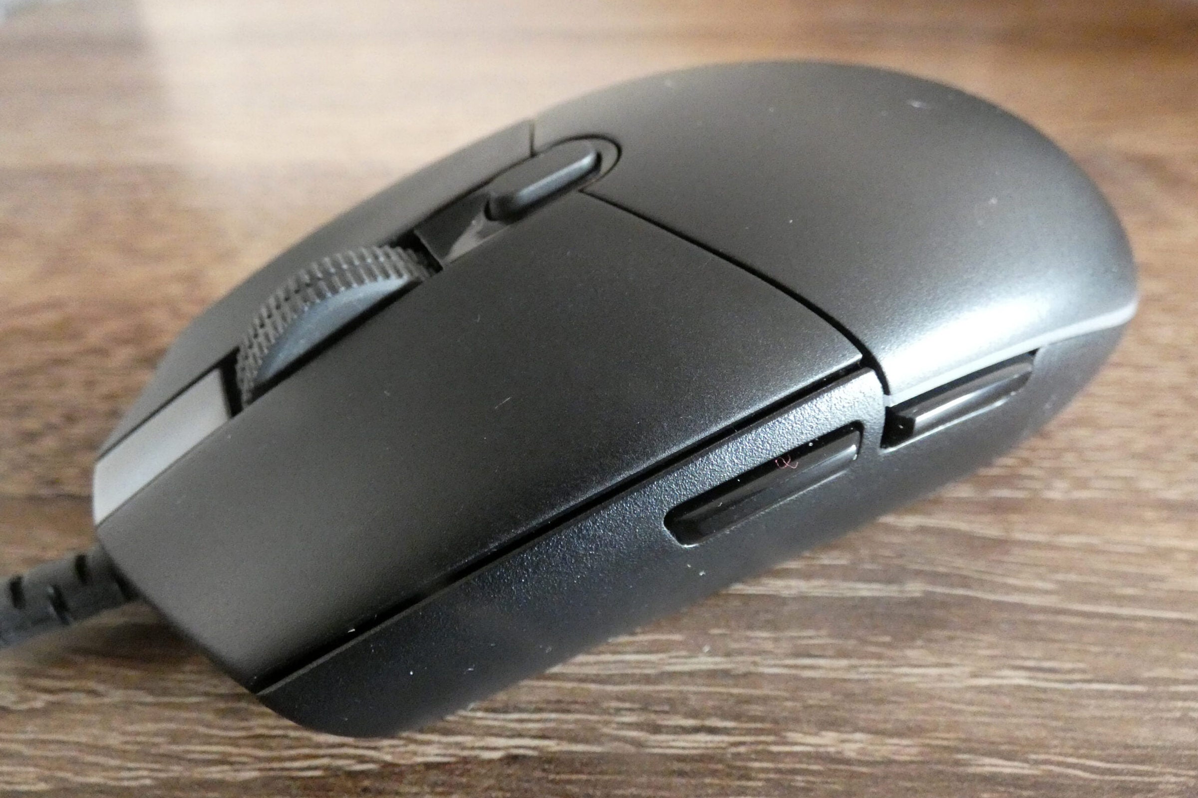 Front right view of a black G203 lightsync mouse, with close up view of additional side buttons