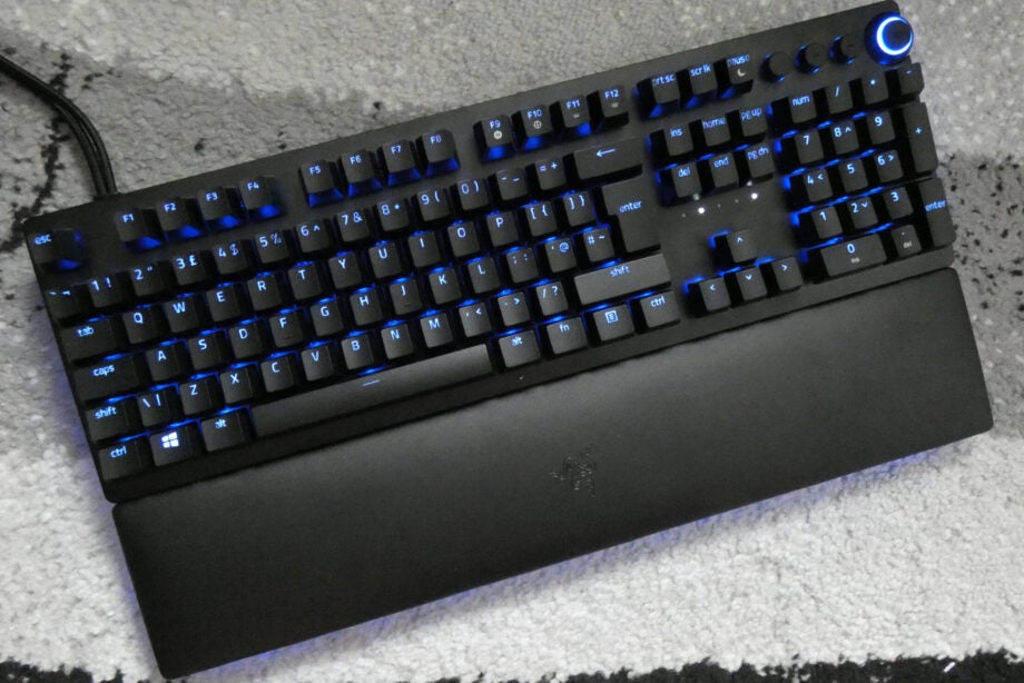 View from top, of a black Huntsman V2 analog keyboard with blue lights beneath the keys