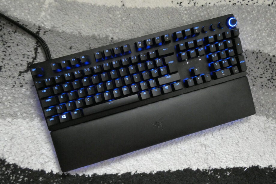 View from top, of a black Huntsman V2 analog keyboard with blue lights beneath the keys