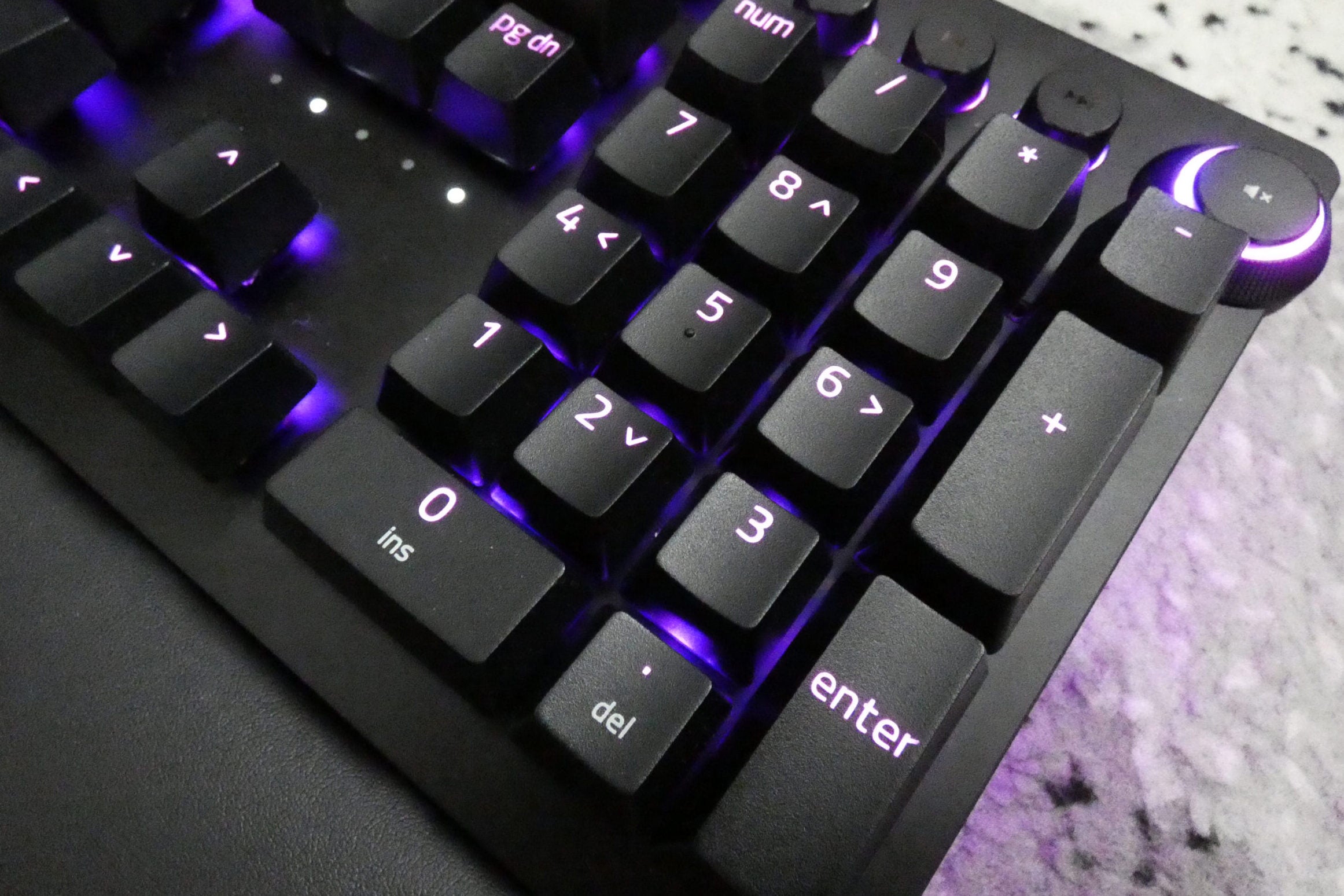 Razer Huntsman V2 AnalogClose up image of a black Huntsman V2 Analog keyboard's numpad section with blue light beneath the keys