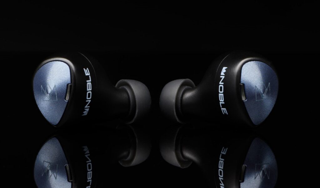 Noble Falcon Pro True WirelessBlack-blue Noble TWS Falcon Pro earbuds resting on black background