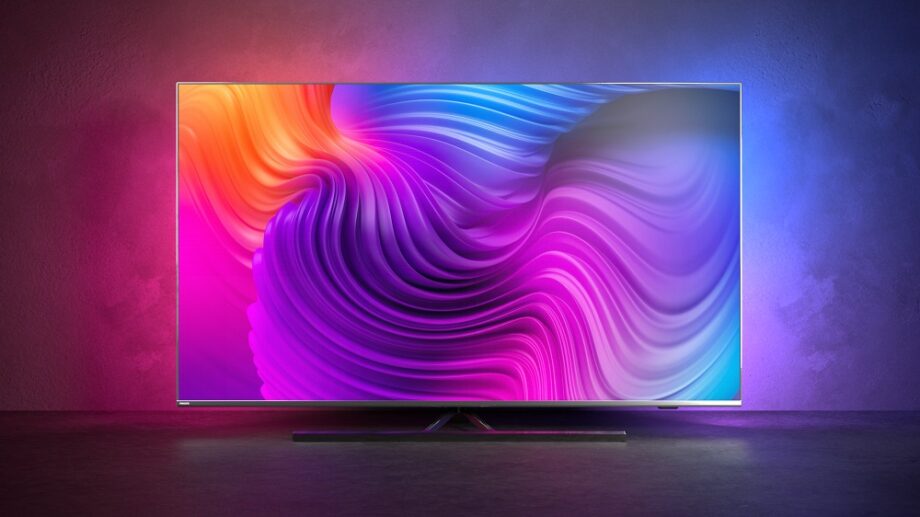 A silver Philips 8506 TV standing in a colorful background, displaying a colorful wallpaper