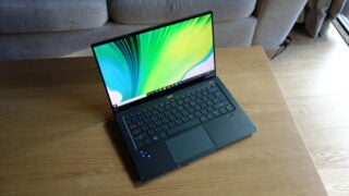 fully opened Acer laptop view with screen brightly on and placed in diagonal position on table