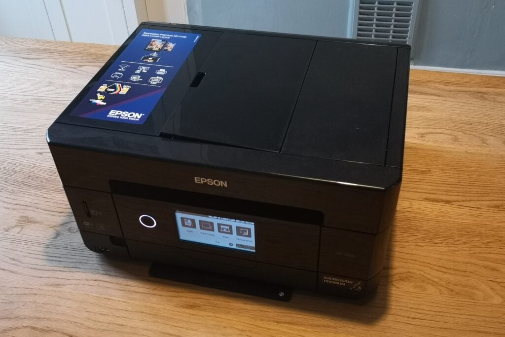Epson XP-7100all covered black Epson printer with a lit control screen