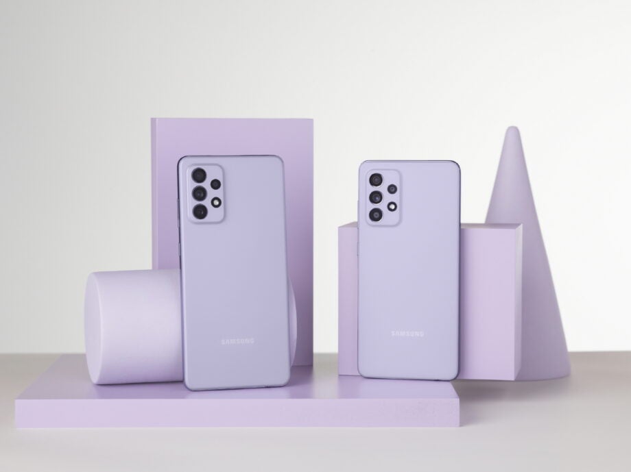 Violet colored Samsung Galaxy A52 and A72 standing against their boxes