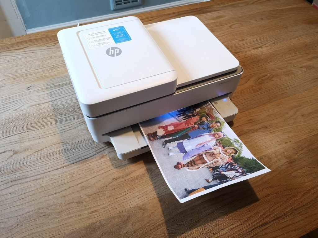 Front view of a white HP Envy Pro 6420 printer with color print output