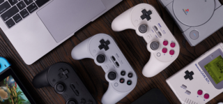 Three remote controllers aligned vertically and a playstation at the top