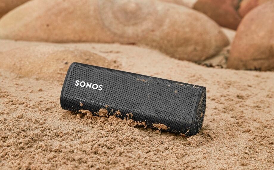 Black sony wireless sound speaker in the sand