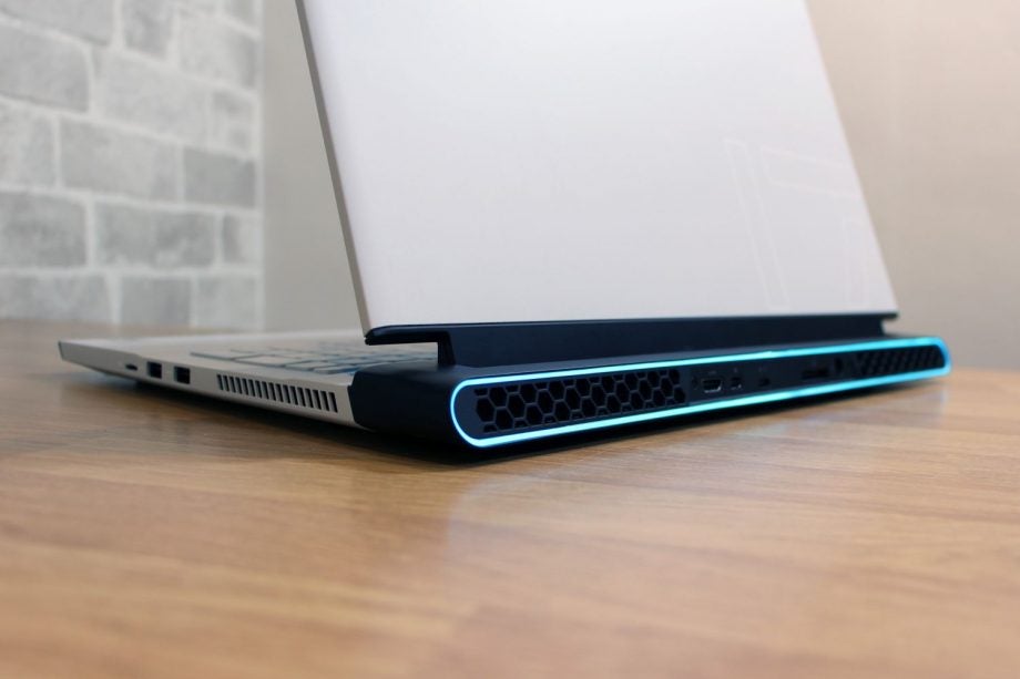 Close up image of a back left bottom view of a silver Alienware M17 R4 laptop facing back