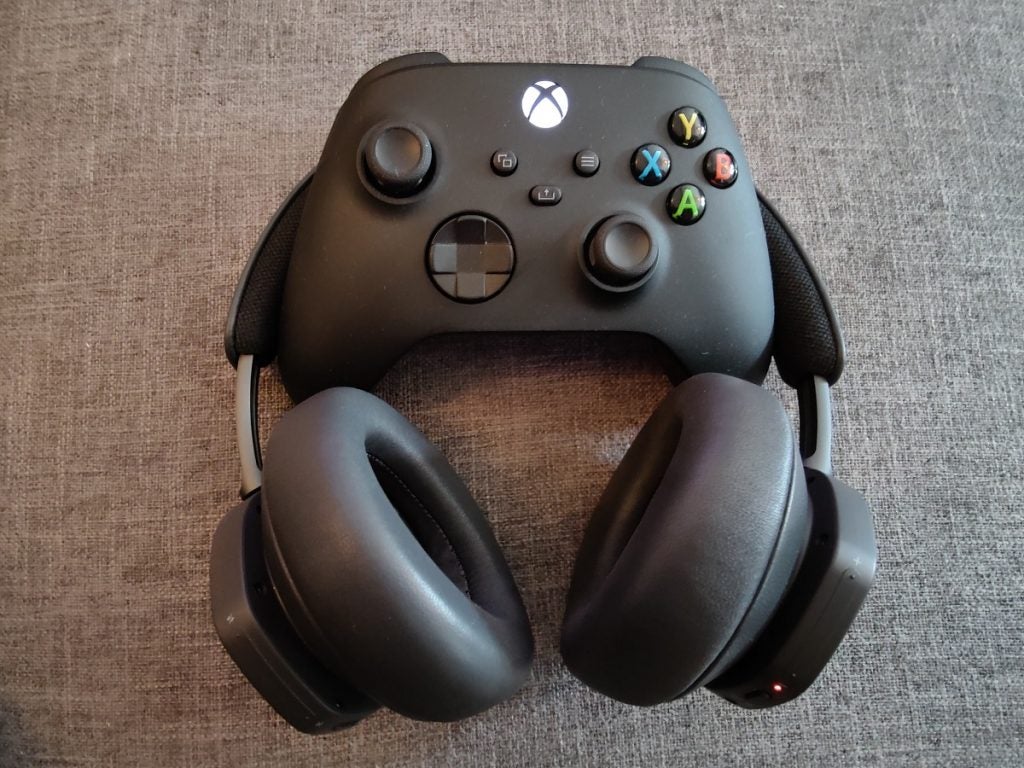Beoplay Portal with Series X controllerBO Beoplay black headphones and black XBOX controller on the top