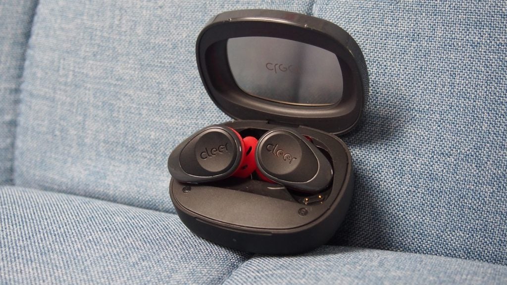 Black and red Cleer Goal earbuds resting in it's black case