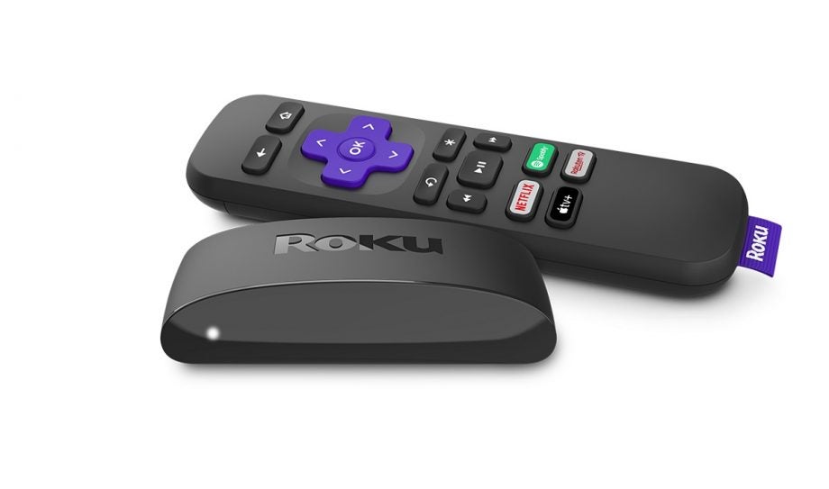 Black Roku TV box with remote on white background