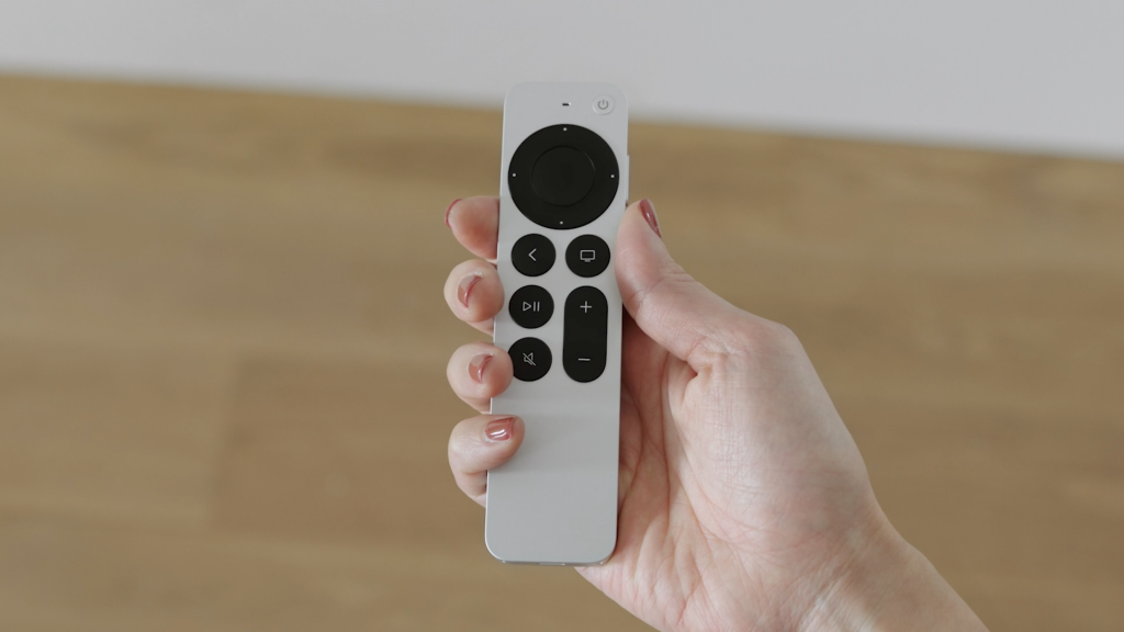The new Apple Siri remoteBlack Apple TV box and its white remote with black keys, all on a white background
