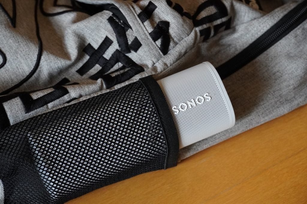 Sonos Roam in rucksackA white Sonos Roam speaker resting in it's black cover