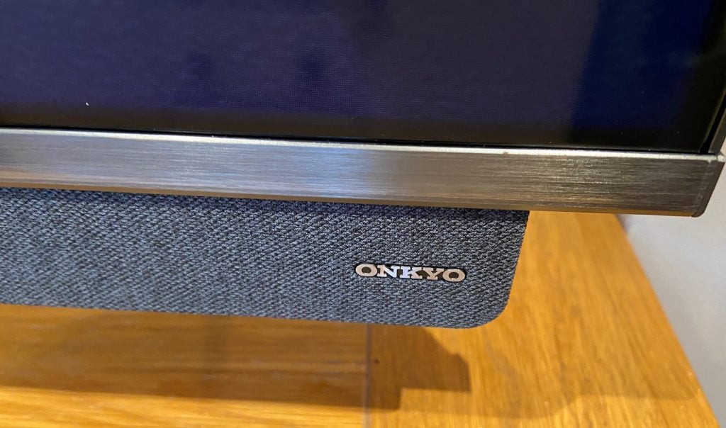 The TCL 65C815K carries an Onkyo-designed sound system.Close up image of TCL65C815's silver Onkyo soundbar