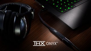 A black THX Onyx's DAC/Amp for your headphones connected to laptop and headphones