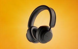 Image of a black Urbanista Los Angeles headphones on a yellow background