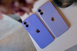 Close up image of two purple iPhone placed upside down on a white table