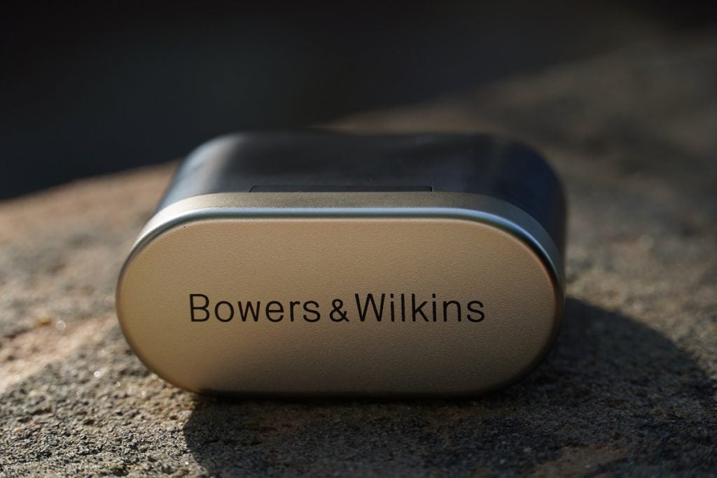 Bowers & Wilkins PI7 charging caseBlack and silver Bowers and Wilkins P17 wireless earbud's case standing on ground with blurred background