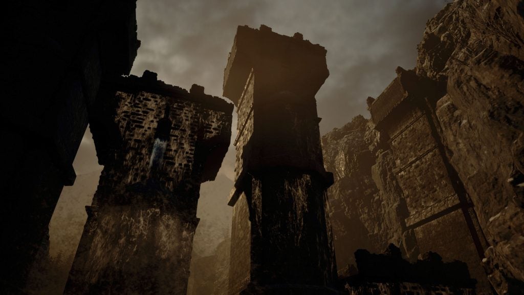 A scene from Resident Evil Village game, huge old broken pillars standing in a broken place