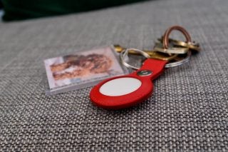 Apple AirTag in a leather holder in red