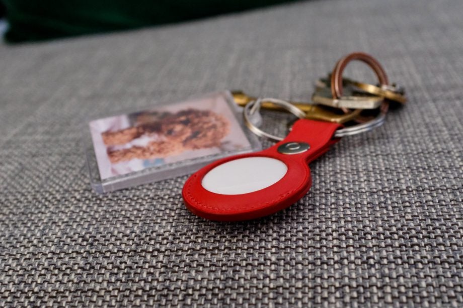 Apple AirTag in a leather holder in red