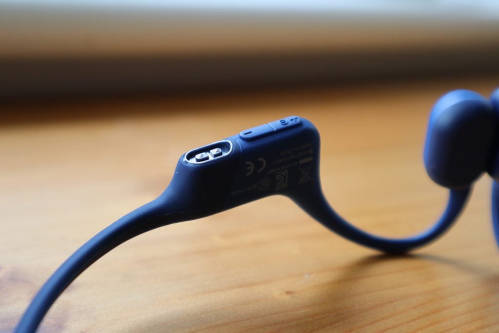 The underside of the Aftershokz Aeropex has a charging port and two small buttons for power and volume control
